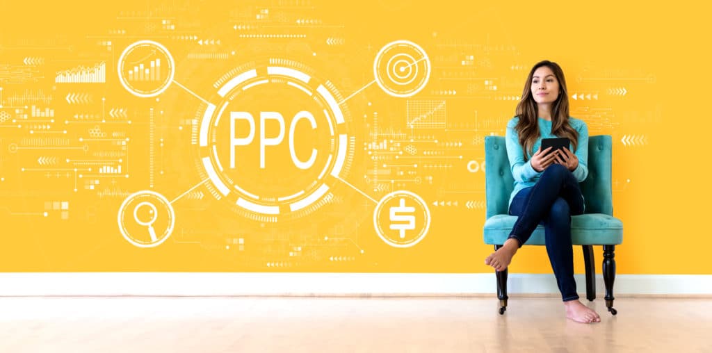 Woman sitting in front of a PPC Marketing logo